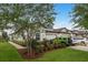 Beautiful home with a well-manicured lawn, lush landscaping, and a three-car garage at 4583 Barletta Ct, Wesley Chapel, FL 33543