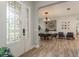 Foyer features wood floors, decorative glass front door, and an arched entryway into the dining area at 4583 Barletta Ct, Wesley Chapel, FL 33543