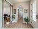 Hallway with an arched ceiling, wood flooring, and access to an office through a sliding barn door at 4583 Barletta Ct, Wesley Chapel, FL 33543