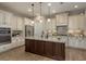 Modern kitchen with granite countertops, stainless steel appliances, an island, and lots of storage at 4583 Barletta Ct, Wesley Chapel, FL 33543
