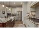 Charming kitchen featuring an island, stainless steel appliances, tile backsplash, and granite countertops at 4583 Barletta Ct, Wesley Chapel, FL 33543