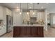 Inviting kitchen with modern appliances, granite countertops, dark island, and a tile backsplash at 4583 Barletta Ct, Wesley Chapel, FL 33543