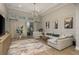 Open-concept living room featuring stylish art, modern furniture, decor, and sliding glass doors to the patio at 4583 Barletta Ct, Wesley Chapel, FL 33543