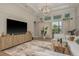 Bright living room with a decorative rug, large windows, modern furniture, and sliding glass doors at 4583 Barletta Ct, Wesley Chapel, FL 33543
