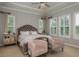 Cozy main bedroom featuring lots of natural light, tray ceilings, and comfortable seating at 4583 Barletta Ct, Wesley Chapel, FL 33543
