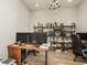 Bright office featuring a chandelier, two monitors, wood floors, and a built-in bookshelf at 4583 Barletta Ct, Wesley Chapel, FL 33543