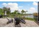 An outdoor patio space offers comfortable seating around a fire pit and a view of the lake at 4583 Barletta Ct, Wesley Chapel, FL 33543
