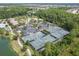 Aerial shot showcasing tennis courts next to a pool and clubhouse with parking at 4583 Barletta Ct, Wesley Chapel, FL 33543