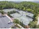 Aerial view of well-maintained community tennis courts with parking and landscaping, promoting an active lifestyle at 4583 Barletta Ct, Wesley Chapel, FL 33543