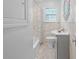 Bright bathroom featuring marble tile, a stylish sink, and a shower-tub combination at 475 28Th N Ave, St Petersburg, FL 33704