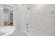 Bright bathroom featuring marble tile, a stylish sink, and a shower-tub combination at 475 28Th N Ave, St Petersburg, FL 33704