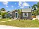 Charming exterior showcasing the front yard, blue door, and classic architectural details at 475 28Th N Ave, St Petersburg, FL 33704