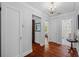 Hallway with hardwood floors and a chandelier, with access to multiple rooms at 475 28Th N Ave, St Petersburg, FL 33704