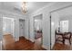 Elegant hallway with hardwood floors, chandelier, and access to multiple rooms at 475 28Th N Ave, St Petersburg, FL 33704
