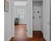 Hallway with hardwood floors and a laundry closet, leading to a cozy living area at 475 28Th N Ave, St Petersburg, FL 33704
