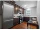 Gourmet kitchen with stainless steel appliances, dark wood cabinetry, and a subway tile backsplash at 475 28Th N Ave, St Petersburg, FL 33704