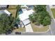 Aerial view showcasing the property, including the in-ground pool, fenced-in yard, and covered parking at 489 Fox Run Trl, Apollo Beach, FL 33572