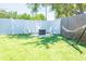 Inviting backyard featuring Adirondack chairs around a fire pit and a relaxing hammock at 489 Fox Run Trl, Apollo Beach, FL 33572