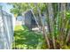 Backyard view showcasing a screened-in porch and lush tropical plants at 489 Fox Run Trl, Apollo Beach, FL 33572