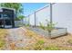 Backyard featuring a metal raised garden bed, with the screen-in lanai visible at 489 Fox Run Trl, Apollo Beach, FL 33572