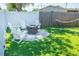 Cozy backyard with Adirondack chairs, fire pit, hammock, and string lights at 489 Fox Run Trl, Apollo Beach, FL 33572