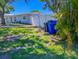 Backyard featuring a privacy fence, lush lawn, mature landscaping, and storage at 489 Fox Run Trl, Apollo Beach, FL 33572