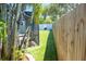 Backyard featuring artificial turf, privacy fence, and a fire pit with Adirondack chairs at 489 Fox Run Trl, Apollo Beach, FL 33572
