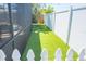Outdoor space shows the artificial turf of the backyard between the privacy fence and screened-in porch at 489 Fox Run Trl, Apollo Beach, FL 33572