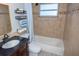 Bathroom featuring dark vanity, decorative shelving, and a shower/tub with a shower curtain at 489 Fox Run Trl, Apollo Beach, FL 33572