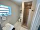 Tiled bathroom featuring a glass-enclosed shower with a black shower curtain rod at 489 Fox Run Trl, Apollo Beach, FL 33572
