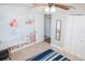 Bright bedroom with ceiling fan features closet doors and a view to an adjacent room at 489 Fox Run Trl, Apollo Beach, FL 33572