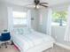 Inviting bedroom featuring a patterned rug, cool color palette and natural light at 489 Fox Run Trl, Apollo Beach, FL 33572