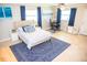 Another view of the bedroom, showcasing windows, a bed, and blue accents at 489 Fox Run Trl, Apollo Beach, FL 33572