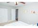Bedroom features a ceiling fan, closet doors, and neutral wall art with animal themes at 489 Fox Run Trl, Apollo Beach, FL 33572