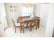 Dining area with a wooden table, six chairs, coastal décor, and natural light at 489 Fox Run Trl, Apollo Beach, FL 33572
