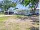 House exterior with an outdoor boat parking spot and shade cover on a sunny day at 489 Fox Run Trl, Apollo Beach, FL 33572