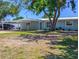 Charming single-story home featuring an attached carport and mature landscaping at 489 Fox Run Trl, Apollo Beach, FL 33572
