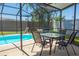 Screened-in pool area featuring a pool, seating, and landscaping at 489 Fox Run Trl, Apollo Beach, FL 33572