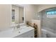 The bathroom has a marble shower and a large vanity with a sink, accompanied by neutral walls and floors at 4976 Cedarbrook Ln, Hernando Beach, FL 34607