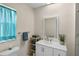 Bathroom featuring a white vanity, framed mirror, and decorative plant on the counter at 4976 Cedarbrook Ln, Hernando Beach, FL 34607