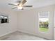 Bright bedroom with tile flooring and two windows allowing natural light at 4976 Cedarbrook Ln, Hernando Beach, FL 34607