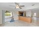 Bright kitchen with granite counters and stainless appliances, adjacent to a tiled sunroom with outdoor seating at 4976 Cedarbrook Ln, Hernando Beach, FL 34607
