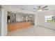 Open concept living room and kitchen area with tiled floors and neutral wall colors at 4976 Cedarbrook Ln, Hernando Beach, FL 34607
