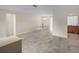 Open-concept living area with neutral tile flooring, dining area, and seamless access to the kitchen at 4976 Cedarbrook Ln, Hernando Beach, FL 34607