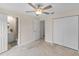 Spacious main bedroom with tile floors, ceiling fan, ensuite bath, and closet at 4976 Cedarbrook Ln, Hernando Beach, FL 34607