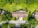 Aerial view of house with well-manicured lawn and mature trees at 507 E Curlew Pl, Tarpon Springs, FL 34689