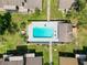 A straight down aerial view of the community pool, and the surrounding townhouses at 507 E Curlew Pl, Tarpon Springs, FL 34689