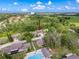 Overhead aerial view of a townhouse complex surrounded by lush green trees at 507 E Curlew Pl, Tarpon Springs, FL 34689