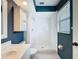 Clean bathroom featuring a walk-in shower, white tile, and stylish vanity at 507 E Curlew Pl, Tarpon Springs, FL 34689