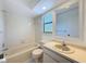 A clean bathroom featuring a shower-tub combo and a single sink vanity at 507 E Curlew Pl, Tarpon Springs, FL 34689